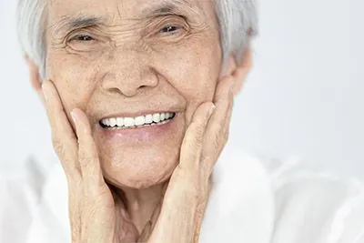 woman showing off her restored smile thanks to dental implants