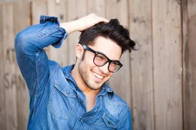 man showing off his smile after getting cosmetic dentistry services