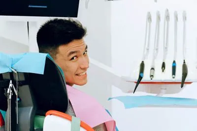 man smiling in a dental chair