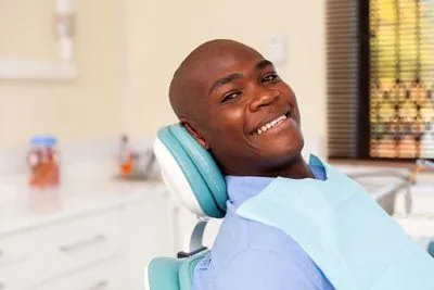 man laying back in the dental chair at Penterson & Booth Family and Cosmetic Dentistry