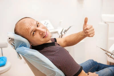 man smiling during his dental visit to Penterson & Booth Family and Cosmetic Dentistry