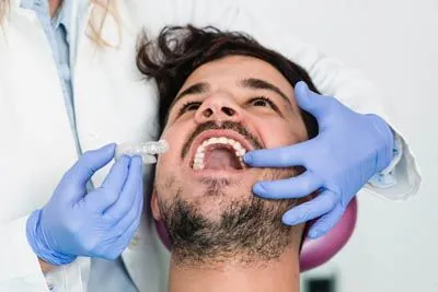 man being fitted for new clear aligners