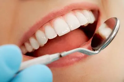 closeup of a patient's smile while receiving dental care