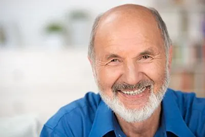 man showing off his freshly restored smile thanks to restorative dentistry