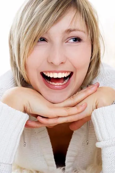 woman smiling big after getting a smile makeover